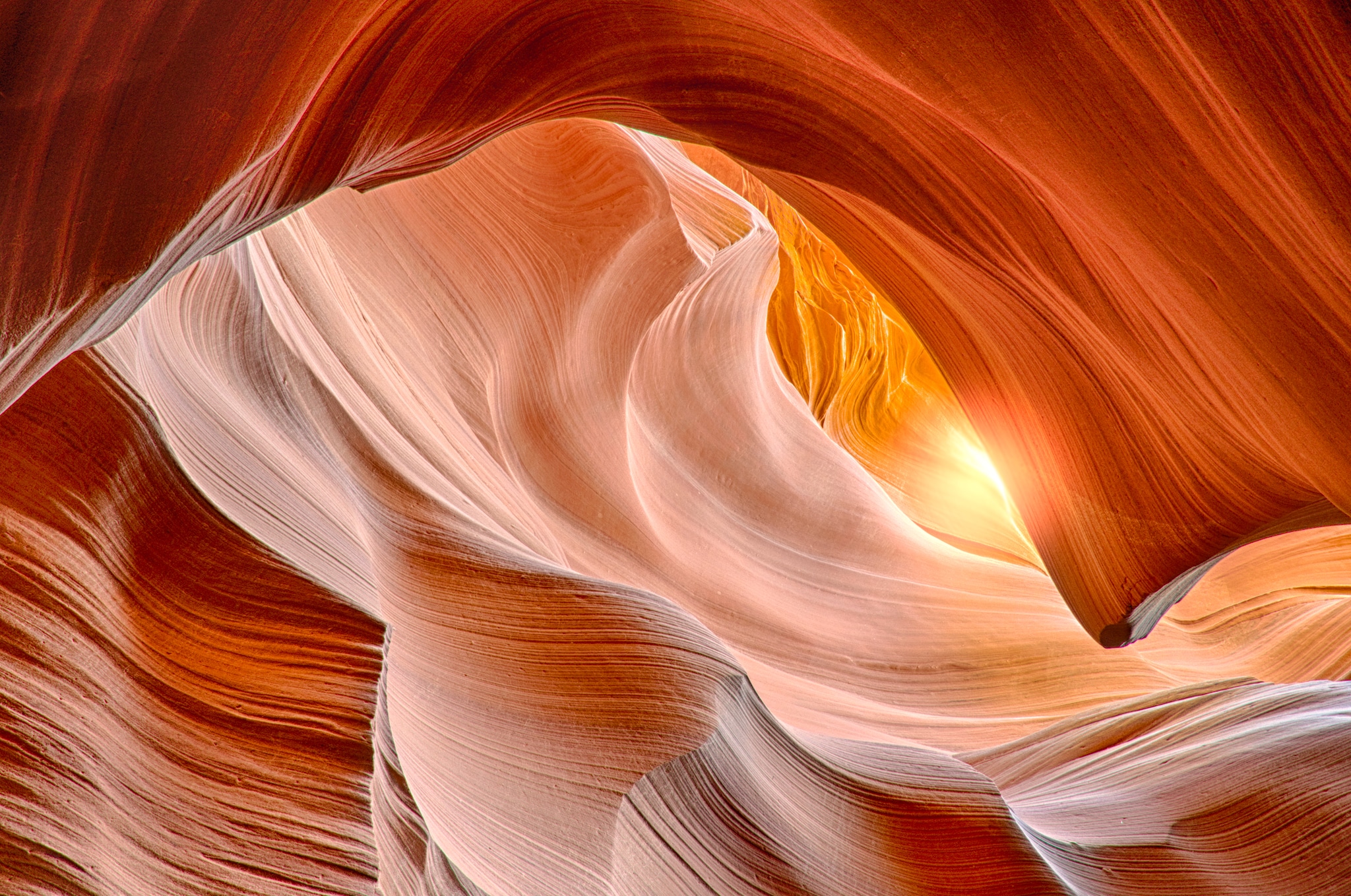 View looking up at the sun in Lower Antelope Canyon, a slot canyon just east of Page, Arizona.