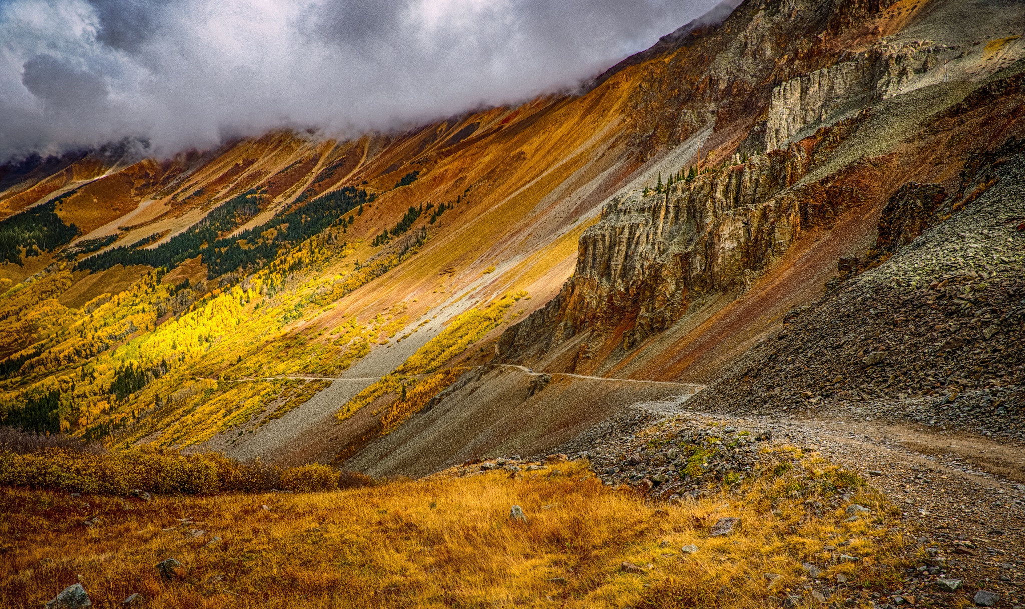 The rust and tan rocks contrast with the golden aspens along Ophir Pass Road, between US 550 and Telluride, Colorado.