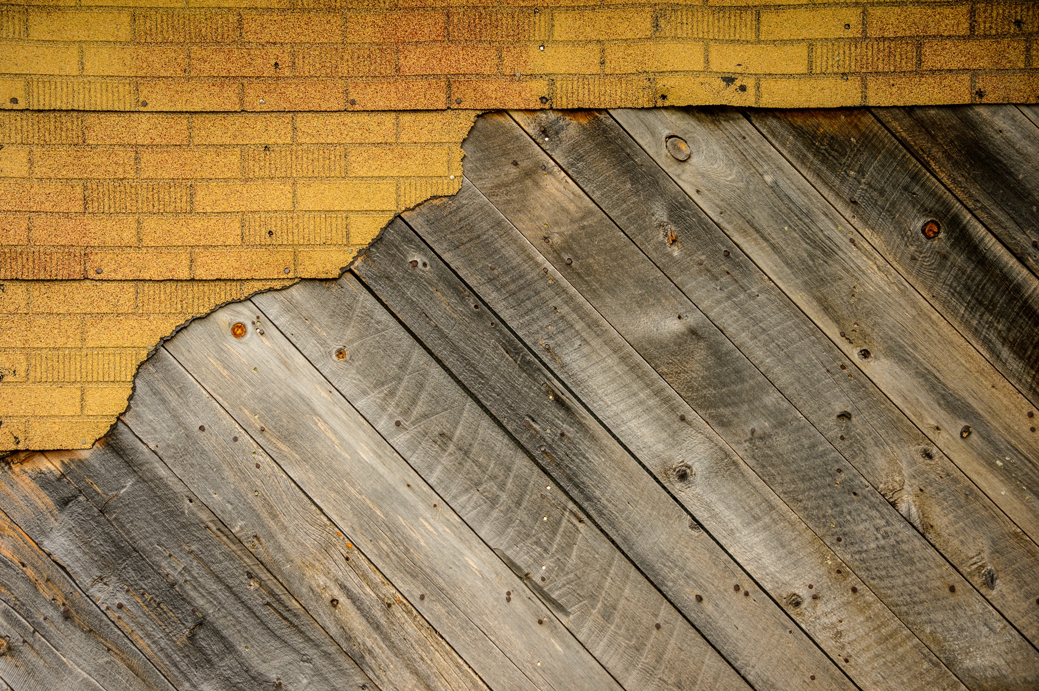 This is a close-up view of old wood and other materials covering the exterior of a structure located in the Animas Forks townsite, northest of Silverton, Colorado, on San Juan County Road 2 near the Alpine Loop.