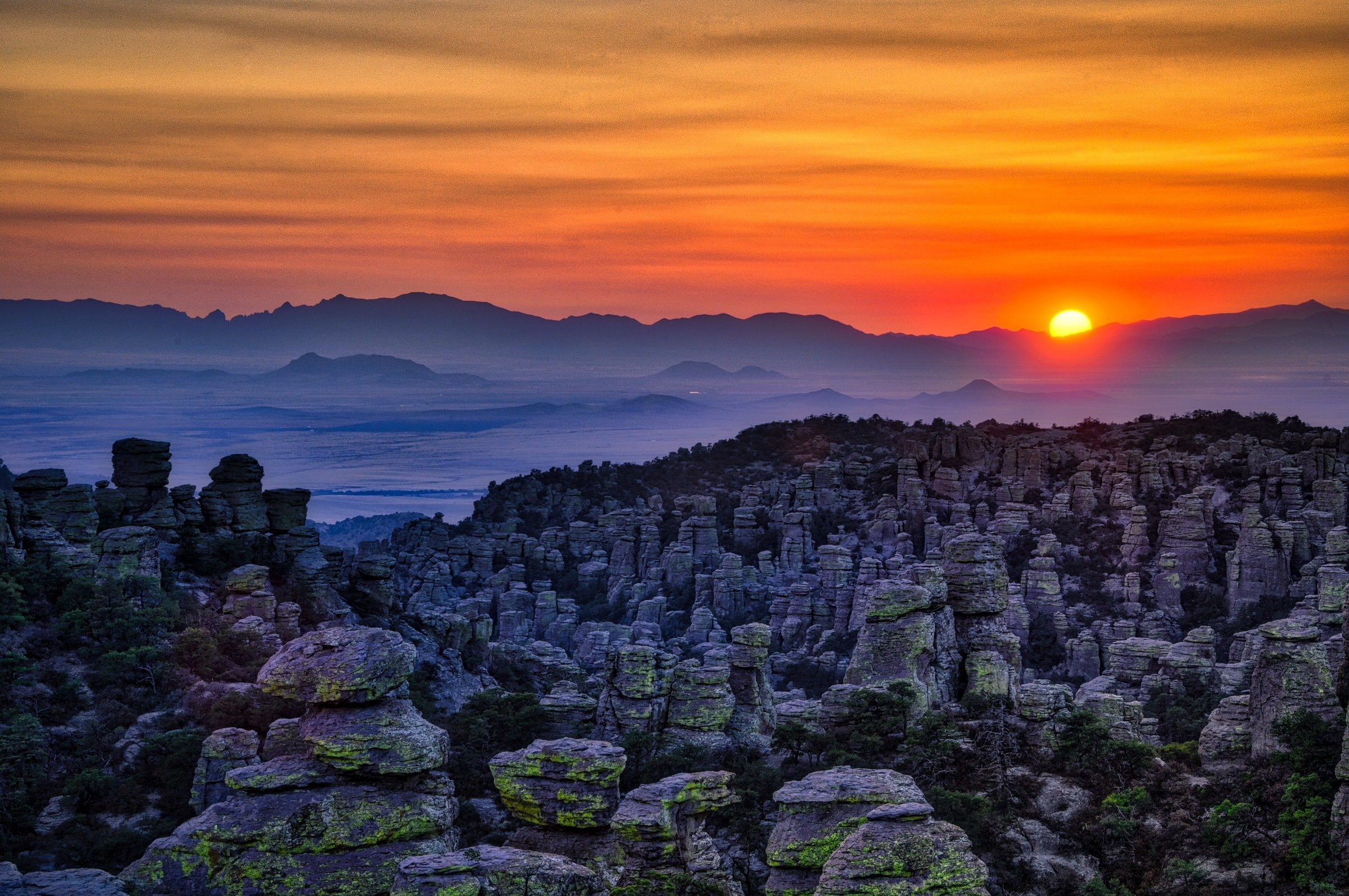 Sunset over Sulfur Springs Valley as seen from Massai Point in Chiricahua National Monument. In the middle distance is Rhyolite Canyon.