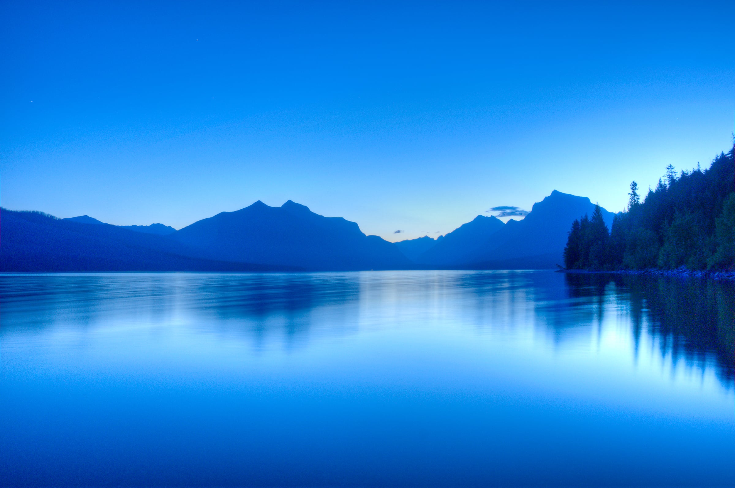 Pre-dawn light on Lake McDonald in Glacier National park. The light really was that blue. It was the most monochromatic dawn I've ever seen. Eerie and tranquil at the same time.