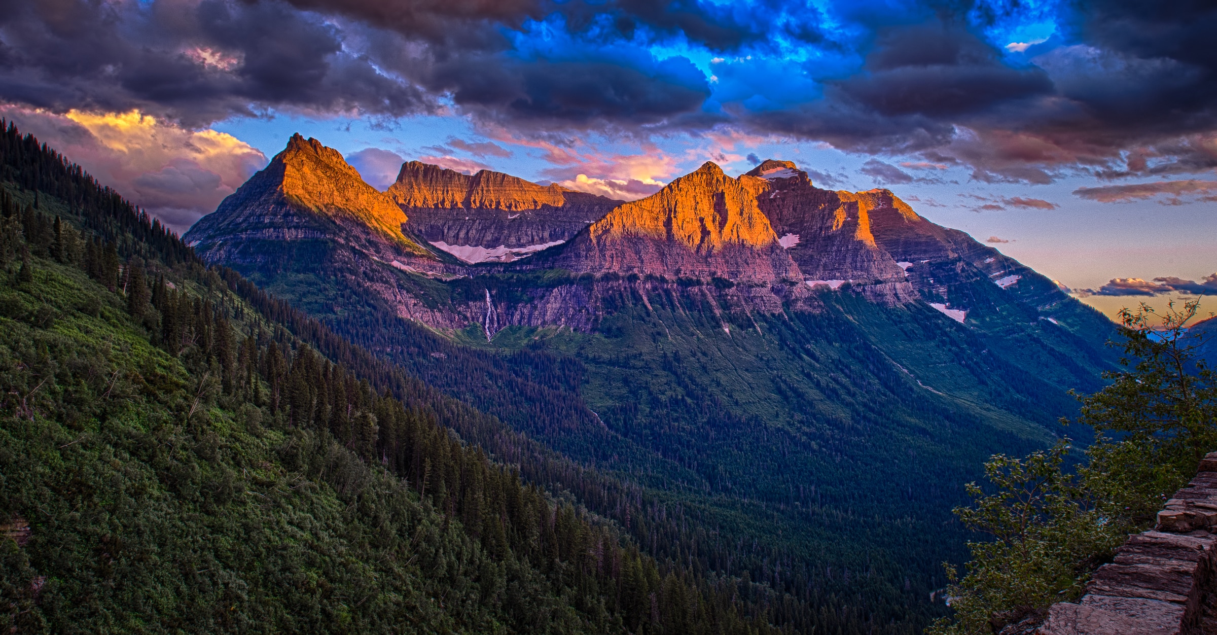 The setting sun lights up peaks along the Going to the Sun Road in Glacier National Park in Montana.
