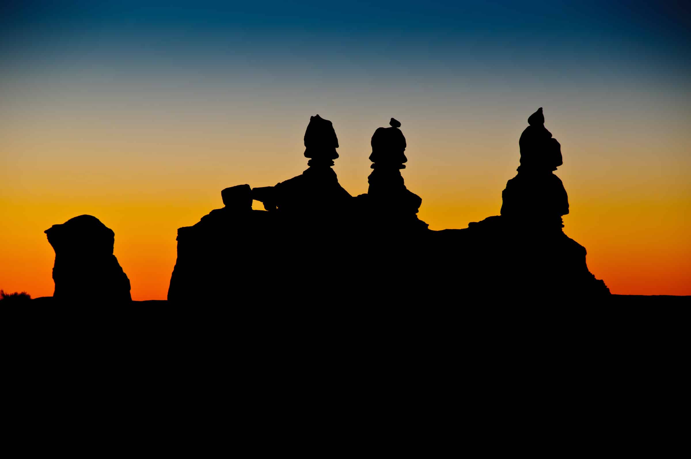 Twilight silhouettes of the rock feature known as The Judges in Goblin Valley.