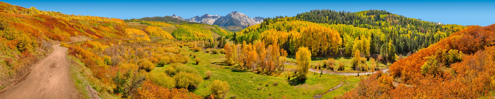 A panoramic view along CR 7, looking toward the Snellels Wilderness showing the autumn colors of aspen, gambel oak, and cottonwoods