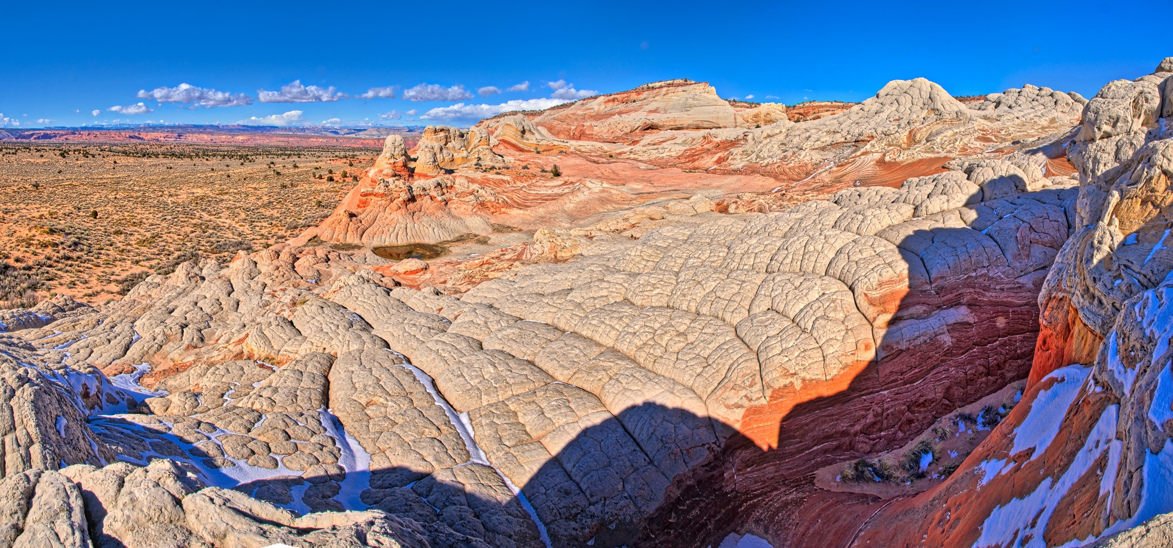 This panoramic view shows the Navajo Sandstone brain rock and the brilliant red swirls in Vermillion Cliffs National Monument.