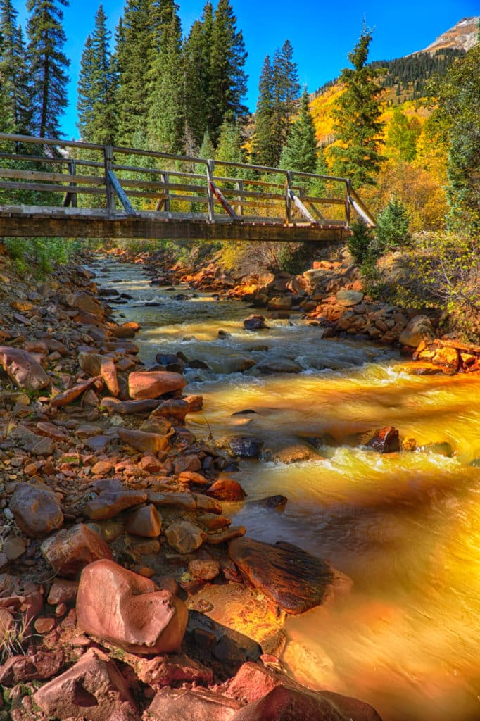 This footbridge crosses Red Mountain Creek and is located near the Ironton Townsite off Highway 550 between Ouray and Silverton, Colorado.