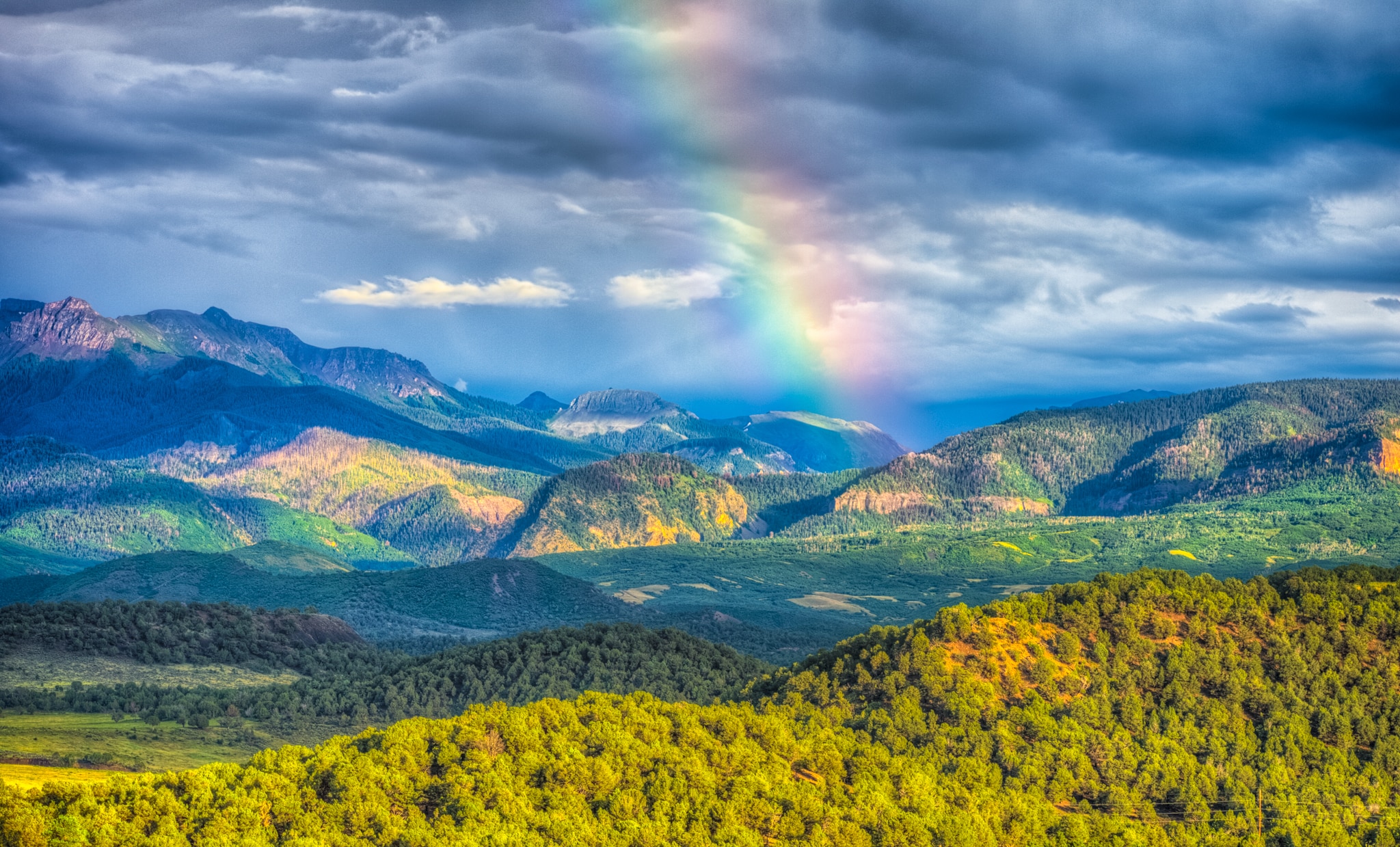 A rainbow paints the sky after a thunderstorm, as seen from Ridgway State Park near Ridgway, Colorado.