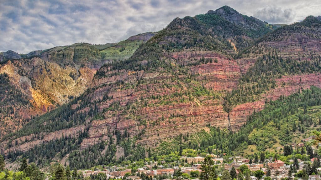 Cascade Falls is visible in the lower-right portion of the frame, above the mountain town of Ouray, Colorado.