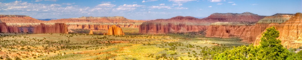 Panoramic view of Cathedral Valley in Capitol Reef National Park, Utah, with the Temples of the Sun and Moon in the distance.