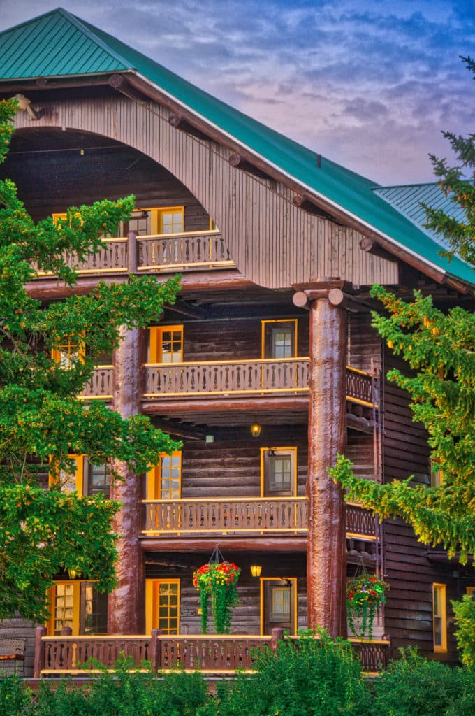 Ionic style columns made from logs hold up the facade of the Glacier Park Lodge in East Glacier, Montana.
