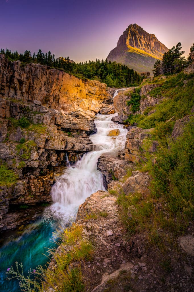 Swiftcurrent Falls at sunset with Grinnel Peak in the background in Glacier Nationalk Park Montana.