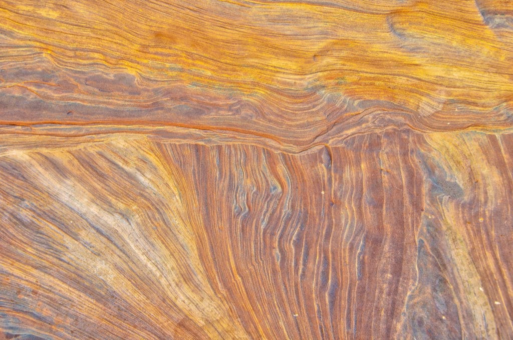 This detail of the wall of Bell Canyon off Wild Horse Road, near Goblin Valley State Park, Utah, looks like wood grain.