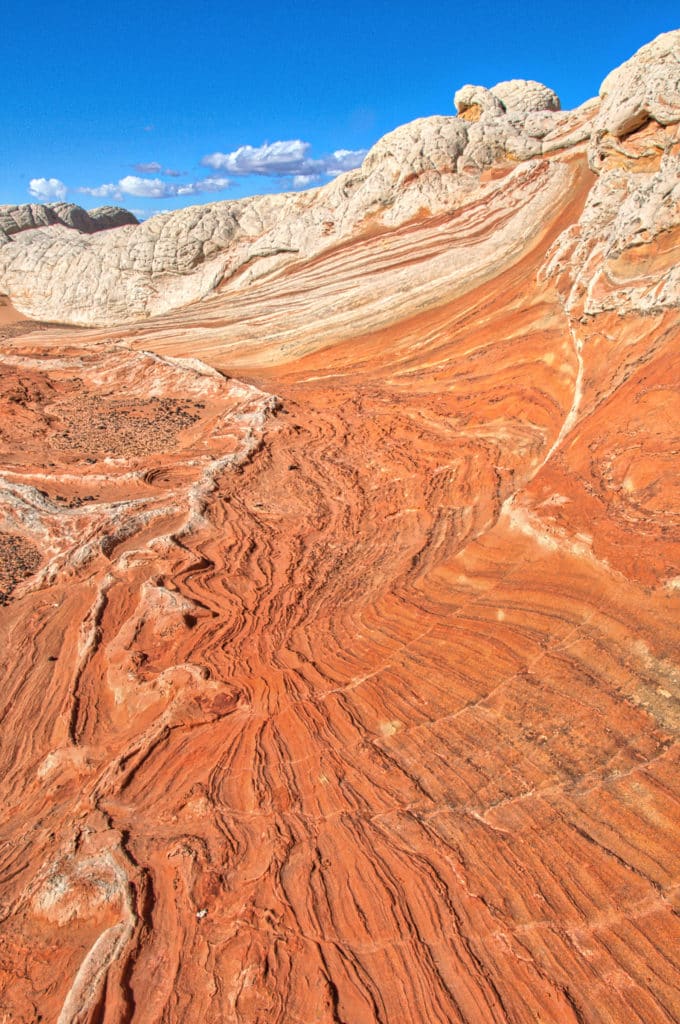 The red layered rocks look like surf rolling in while the whote brain rock look like white caps in Vermillion Cliffs National Monument.