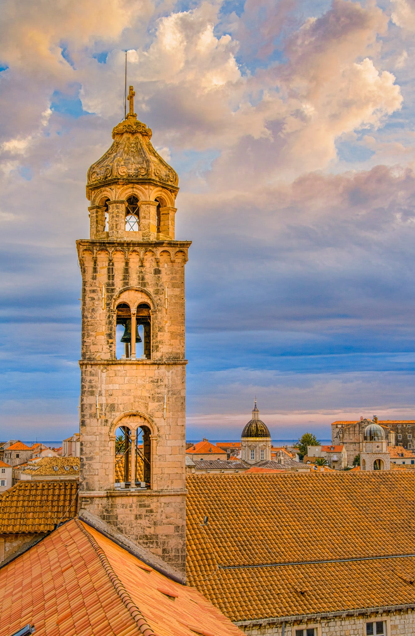 A view of the old Dominican Church and Monastery Bell Tower with Dubrovnik Cathedral and Bell Tower in the distance.