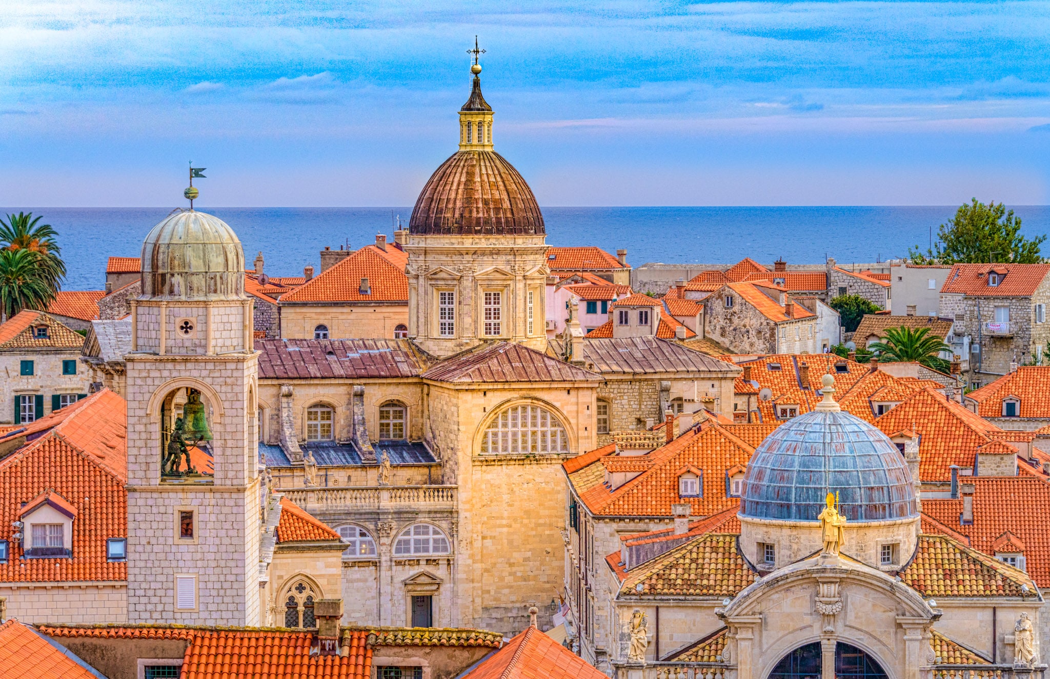 A view from Dubrovnik's city wall toward the Adriatic with the Church of St. Blaise, the Dubrovnik Clock Tower, and the Dubrovnik Cathedral in the foreground.