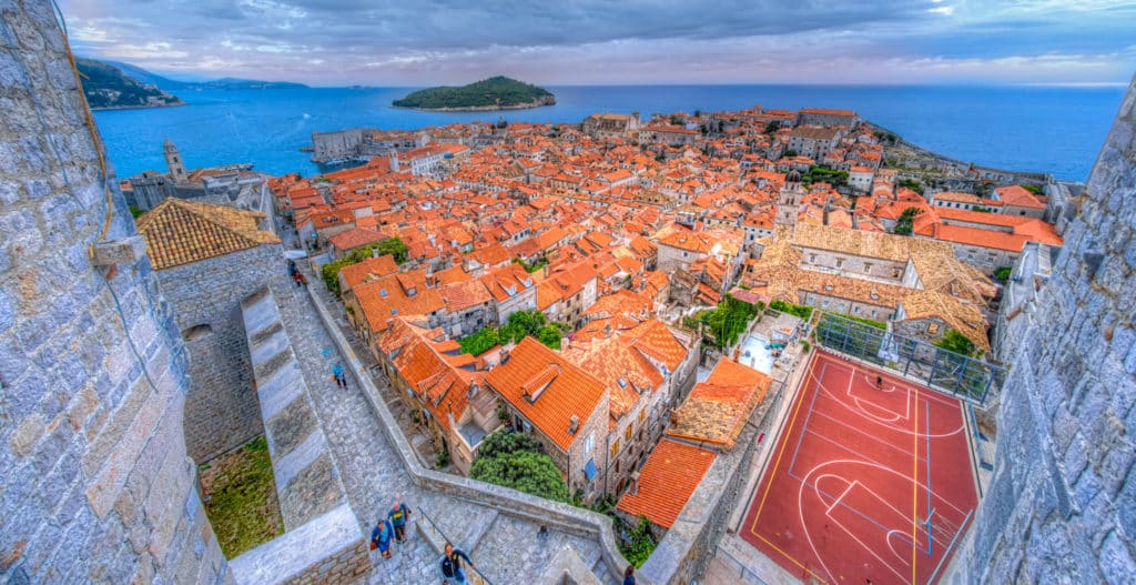 Looking across Dubrovnik Old Town from the Minceta Tower to the island of Lokrum with a soccer/basketball court in the foreground.