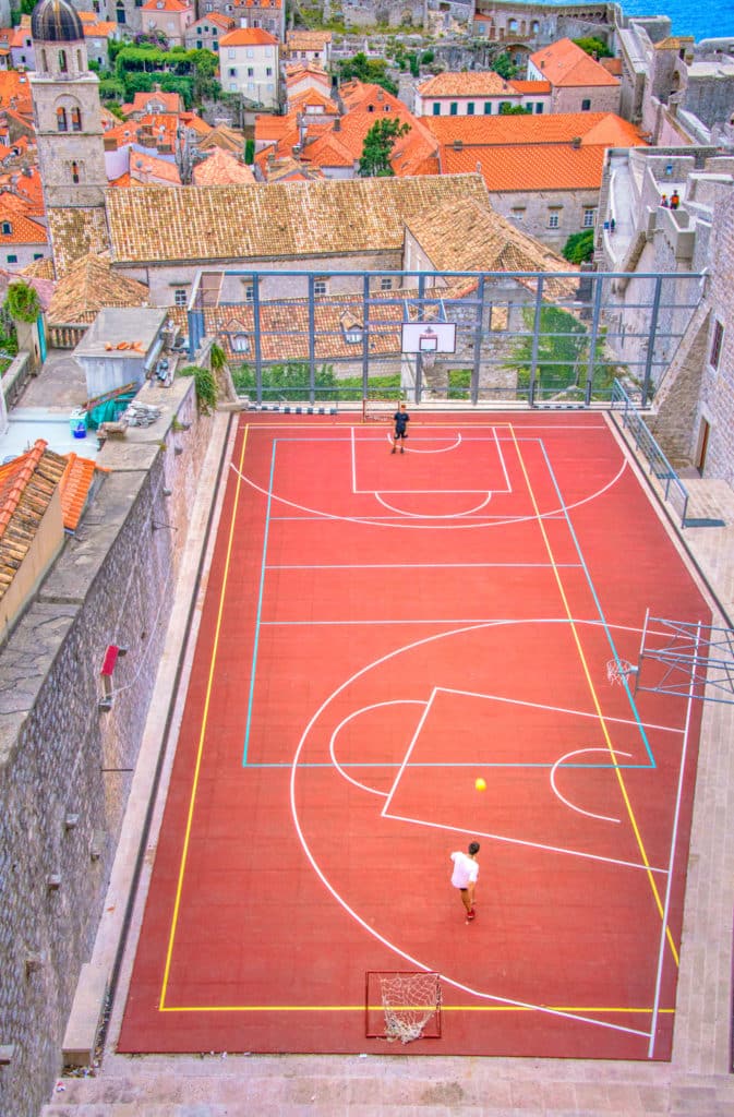 A view of a soccer/basketball court within Dubrovnik Old Town as seen from the Monceta Tower in the city wall.