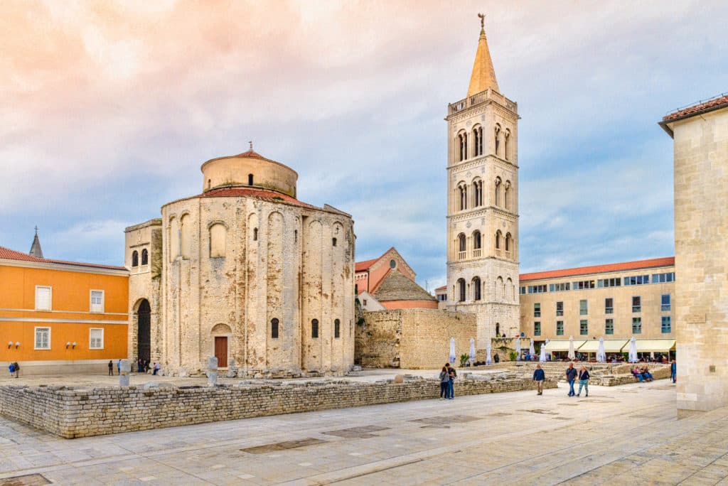 A view of the Romanesque Church of St. Donatus and the bell tower of the Cathedral of St. Anastasia adjacent to remnants of the Roman forum in the Illyrian city of Zadar in Croatia.