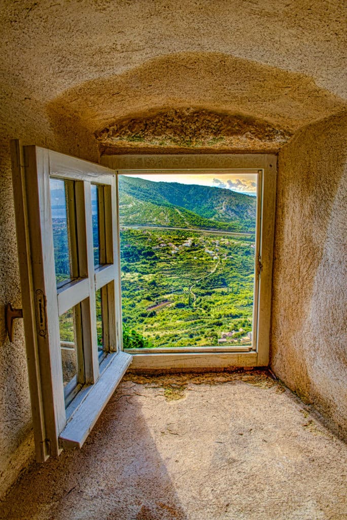 A view of the country side as seen through a window in the House of Dux of Klis Fortress near the Croatian city of Split.