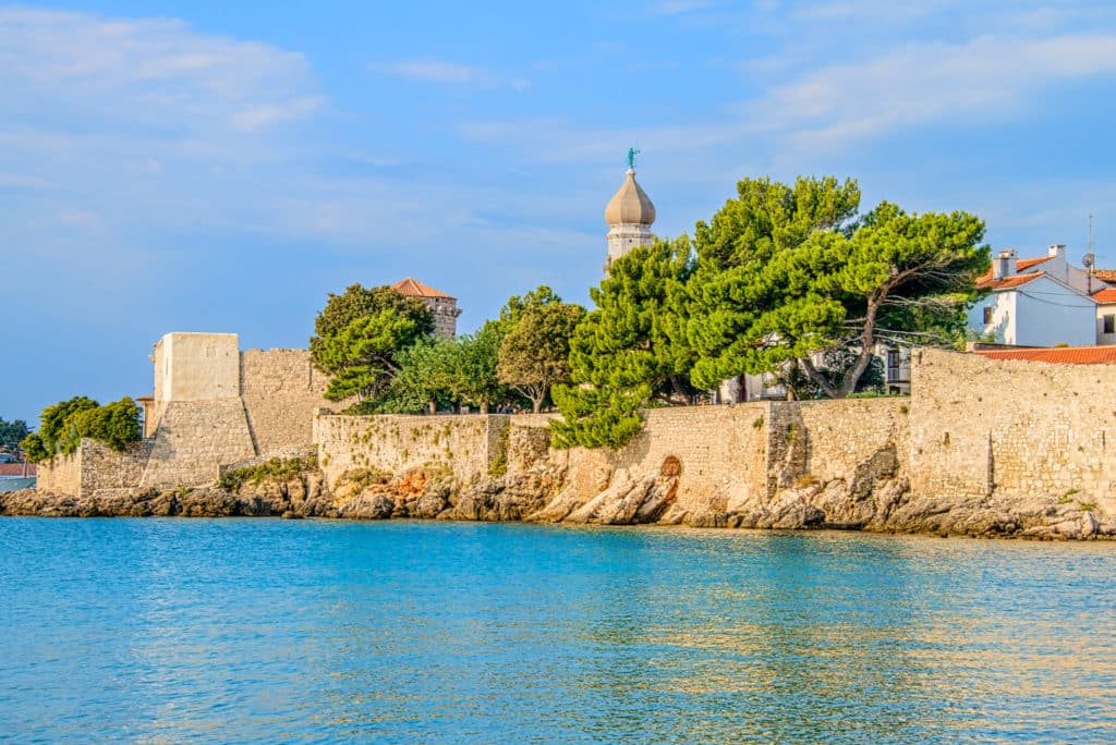 A view of the city walls and Krk Cathedral in Krk, Croatia.