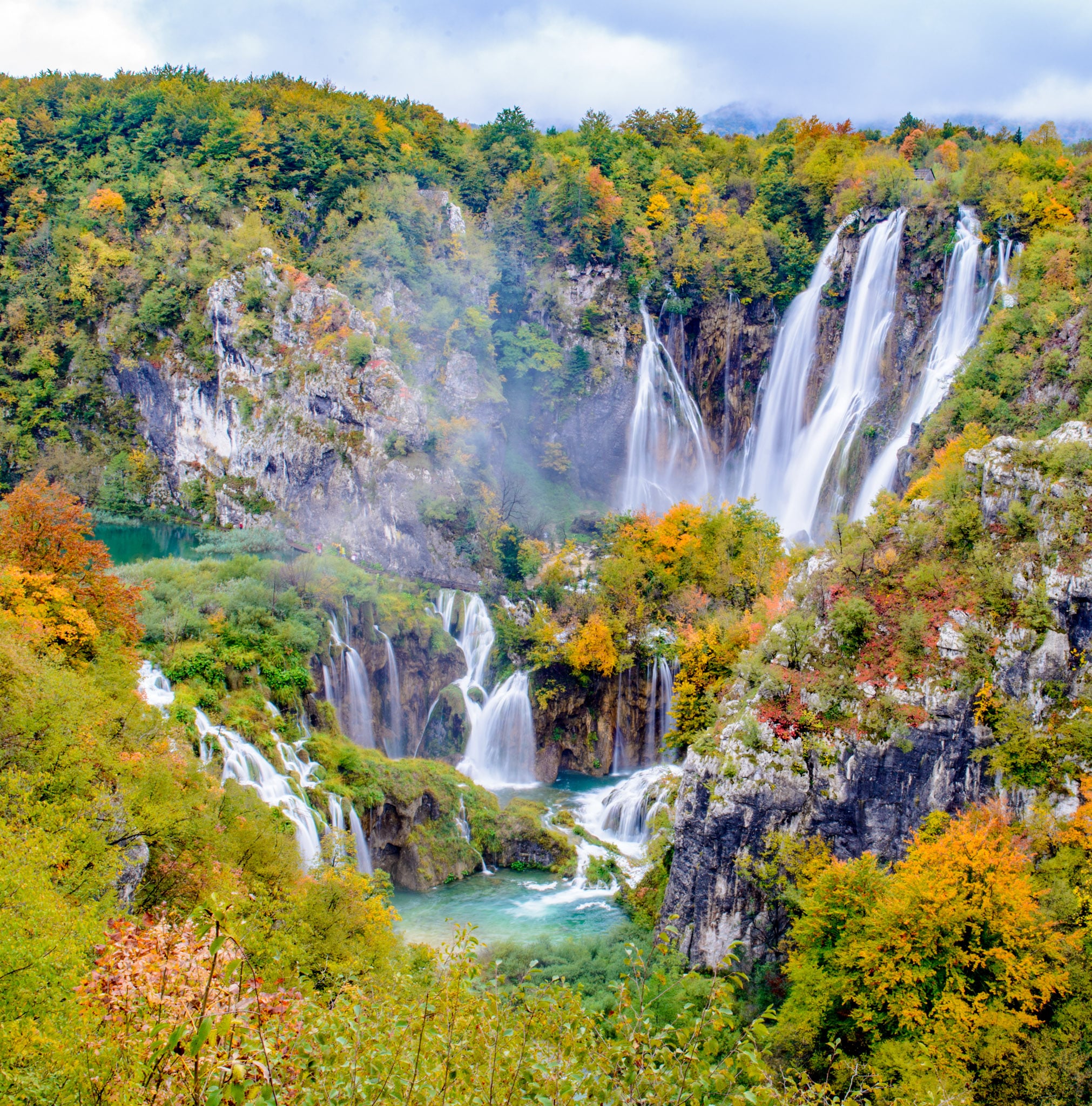 The Big Waterfall, also known as Veliki Slap, surrounded by autumn leaves as seen from just inside Entrance 1 of Plitvice Lakes National Park in Croatia.