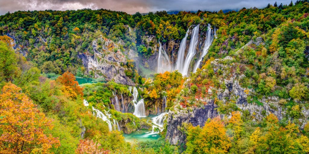 The Big Waterfall, also known as Veliki Slap, surrounded by autumn leaves as seen from just inside Entrance 1 of Plitvice Lakes National Park in Croatia