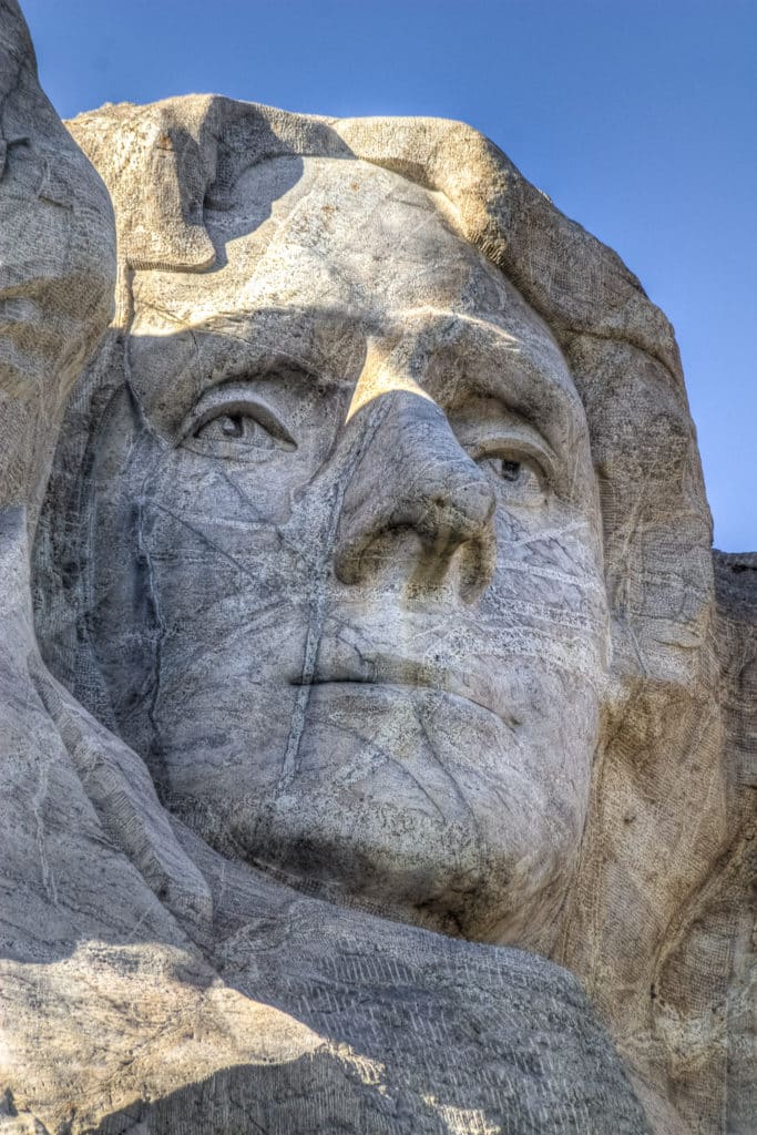 A close-up of the face of President Thomas Jefferson carved into Mt. Rushmore.