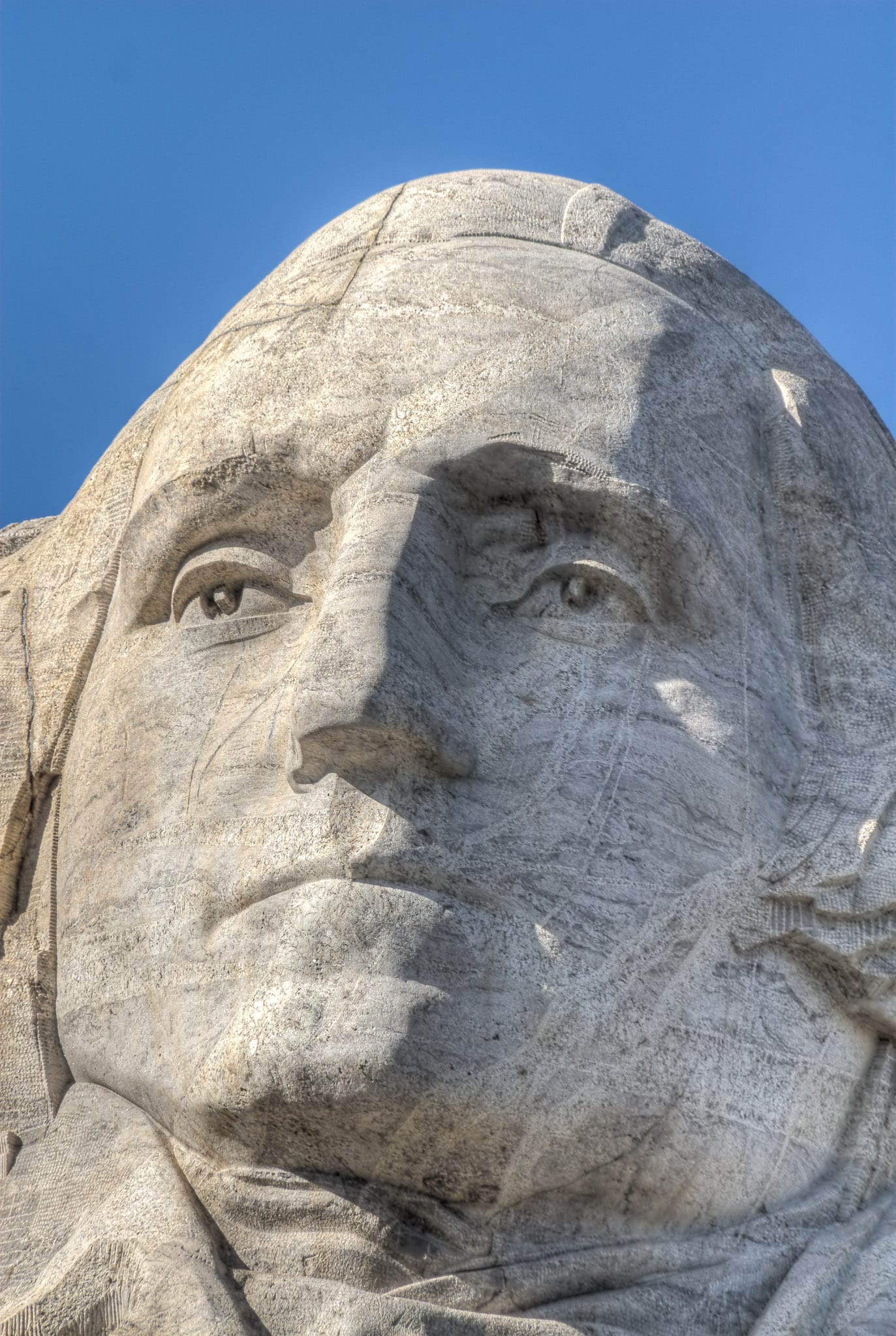 A close-up of the face of President George Washington carved into Mt. Rushmore.