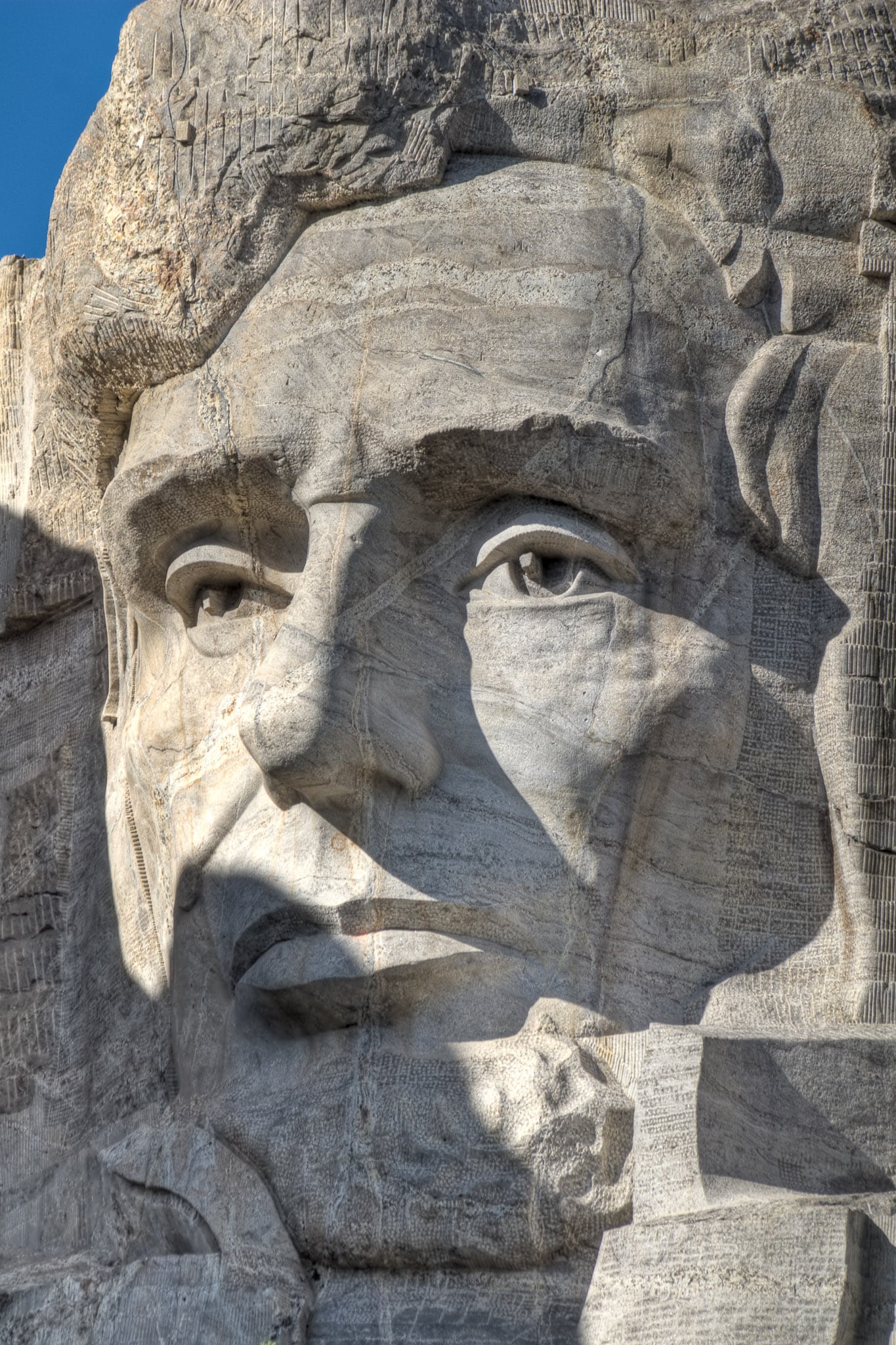 A close-up of the face of President Abraham Lincoln  carved into Mt. Rushmore.