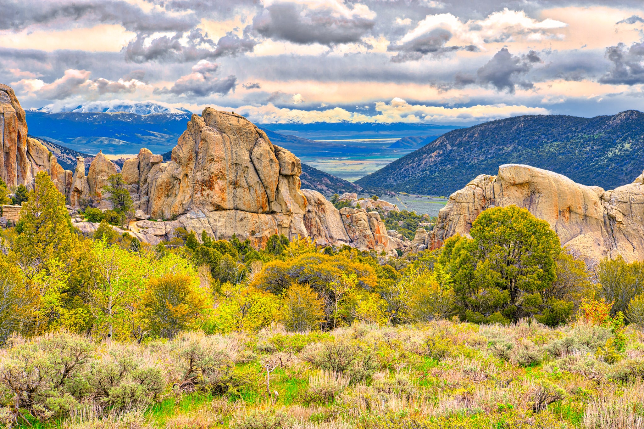 Snow and rain clouds roll over the Albion Mountains approaching the granite formation in City of Rocks National Reserve, near Almo, Idaho.