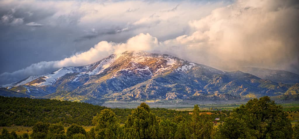 Snow clouds roll down the mountains into City of Rocks National Reserve at sunset, near Almo, Idaho.