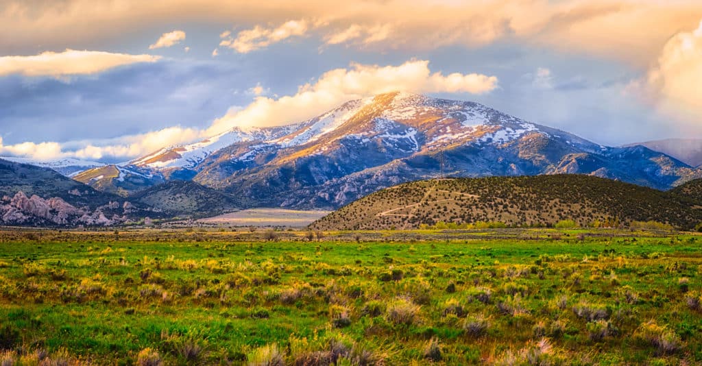 Snow clouds roll down the mountains into City of Rocks National Reserve at sunset, near Almo, Idaho.