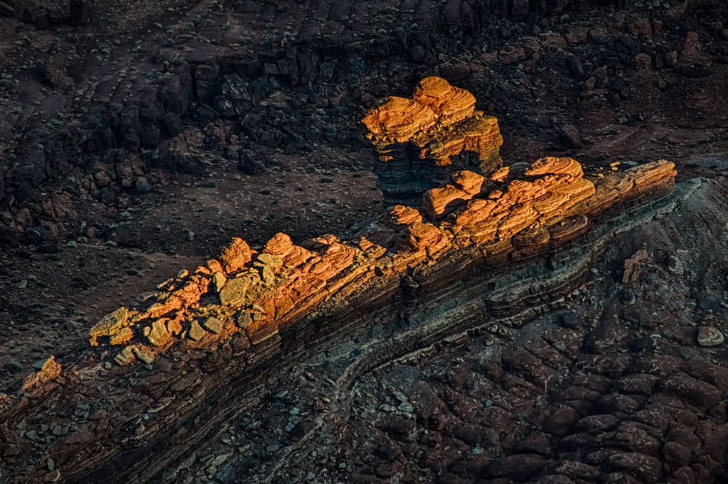 The last sunlight catches the tips of a butte below Dead Horse Point, near Moab Utah.