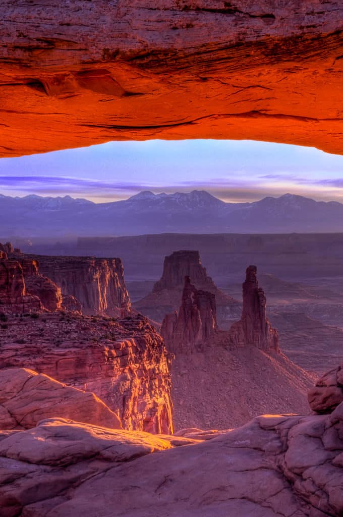 At dawn, looking east through Mesa Arch in Canyonlands National Park.