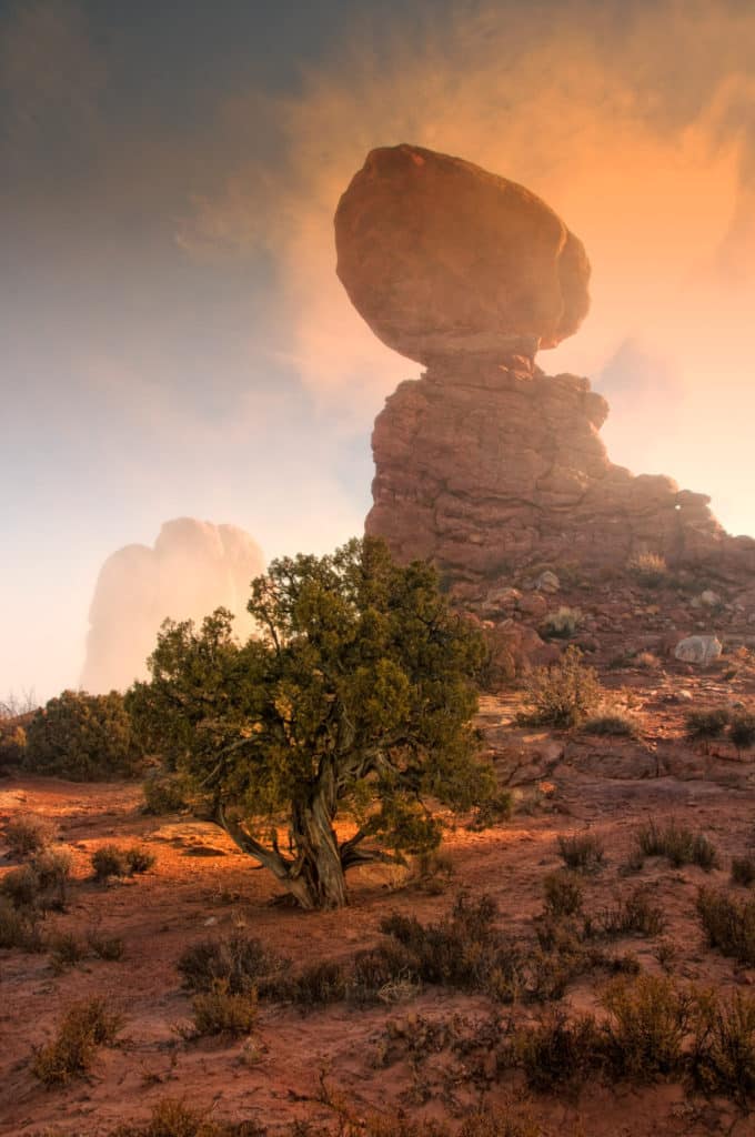 Balanced Rock wrapped in fog at morning in Arches National Park.