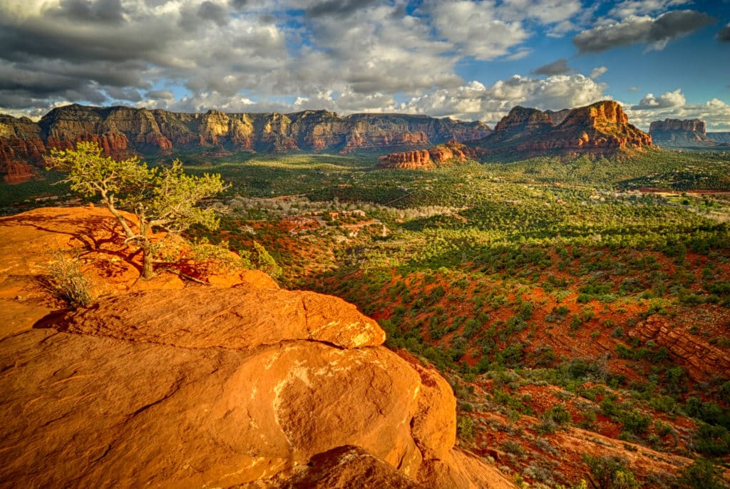 Looking southeast from rock above Airport Road in Sedona, Arizona.Arizona, Sedona, Aorport Road, Twin Buttes, Cathedral Rock, sandstone, sunset, clouds