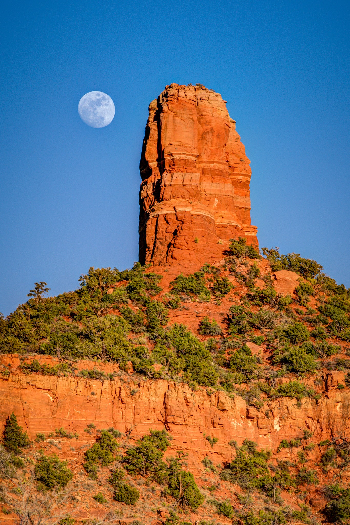 Moon rising over Chimney Rock as seen from Dry Creek Road in Sedona, Arizona.
