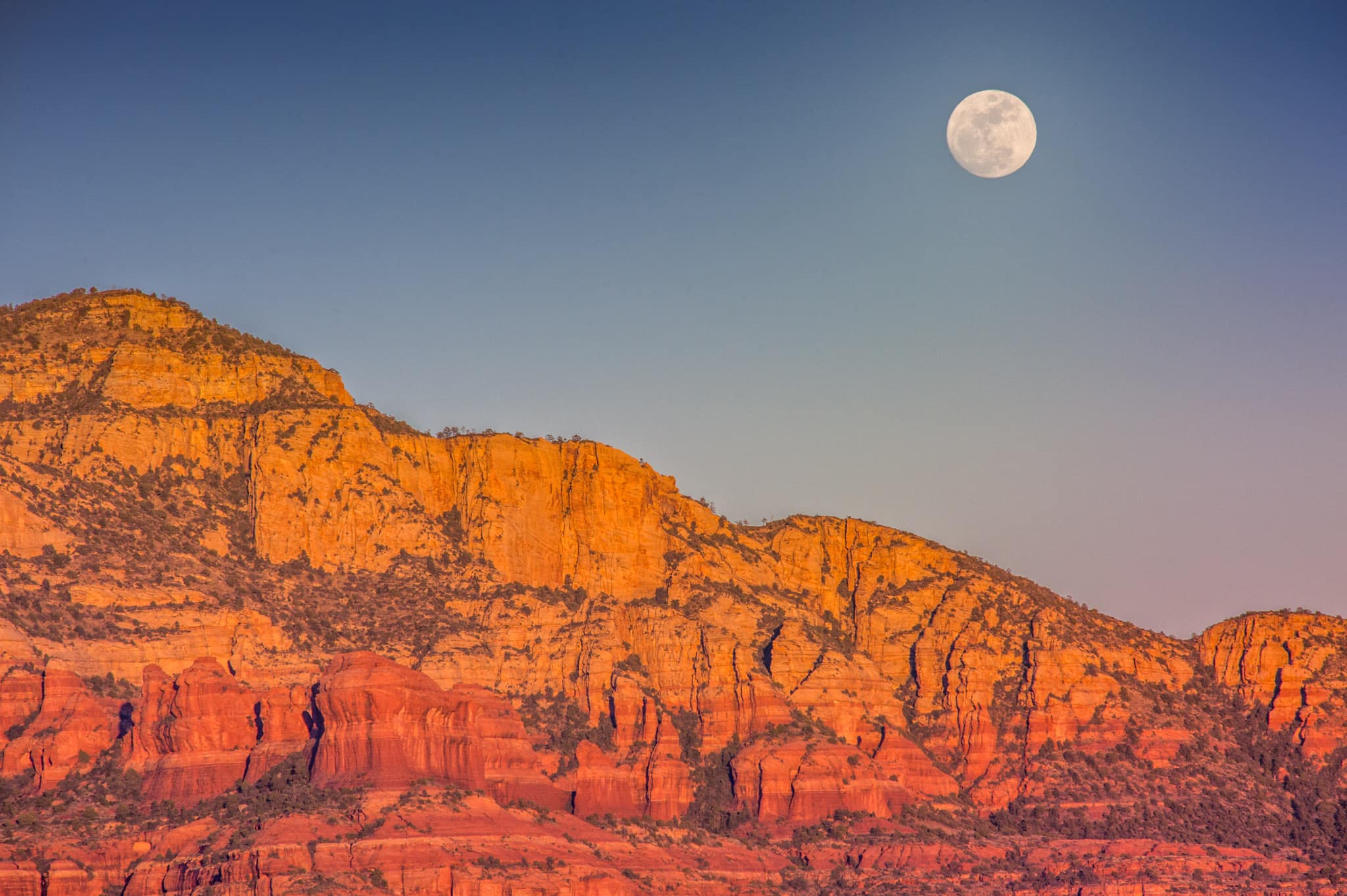 A full moon rises in Sedona, Arizona.