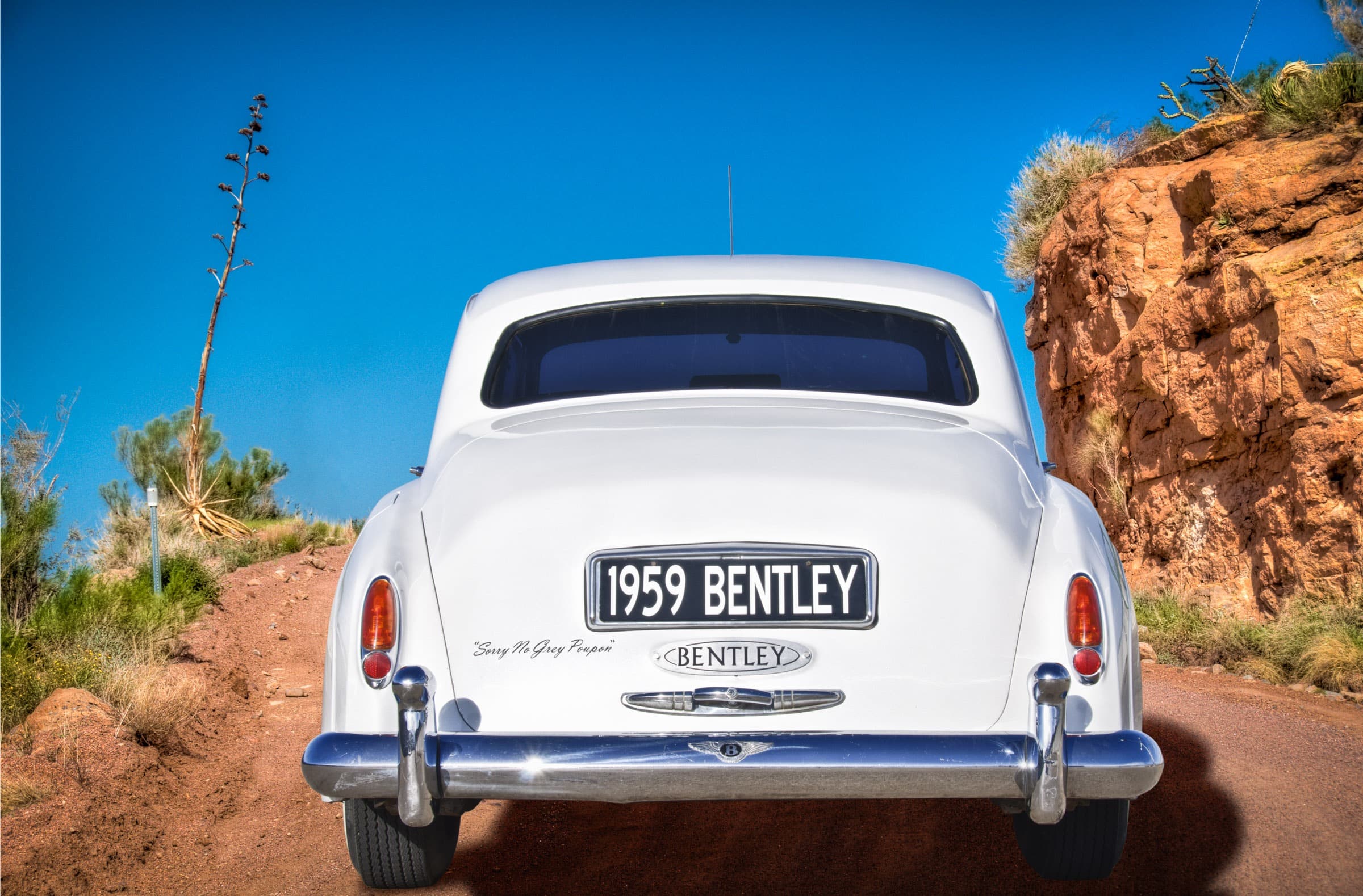 1959 Bentley S1 rear view on a dirt road in Arizona.