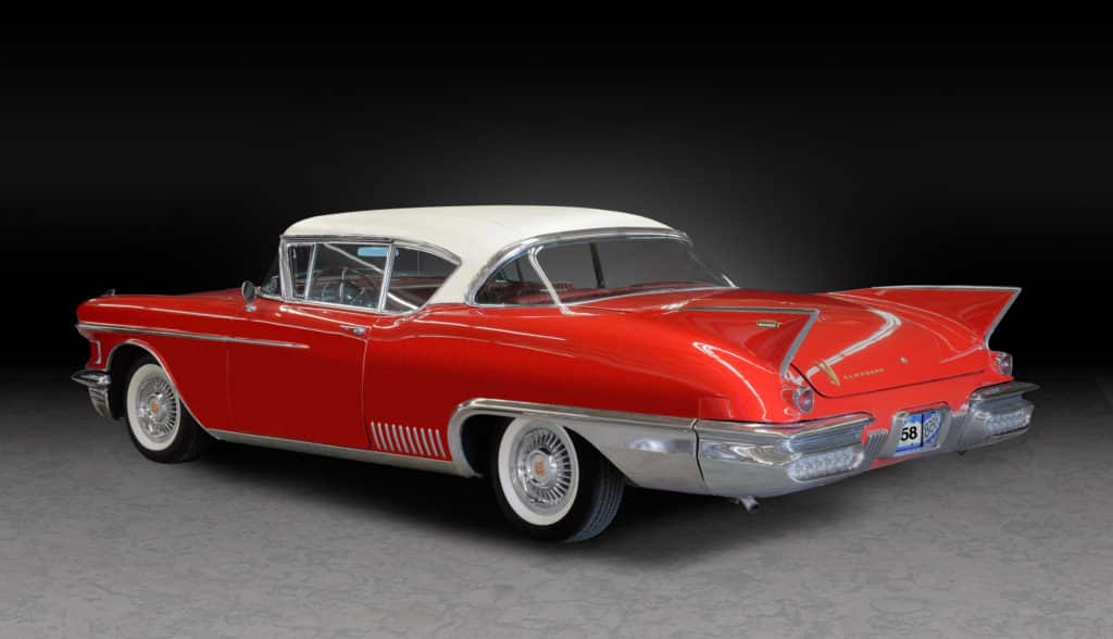1958 Cadillac Eldorado Seville with red body and white roof and red, leather interior.