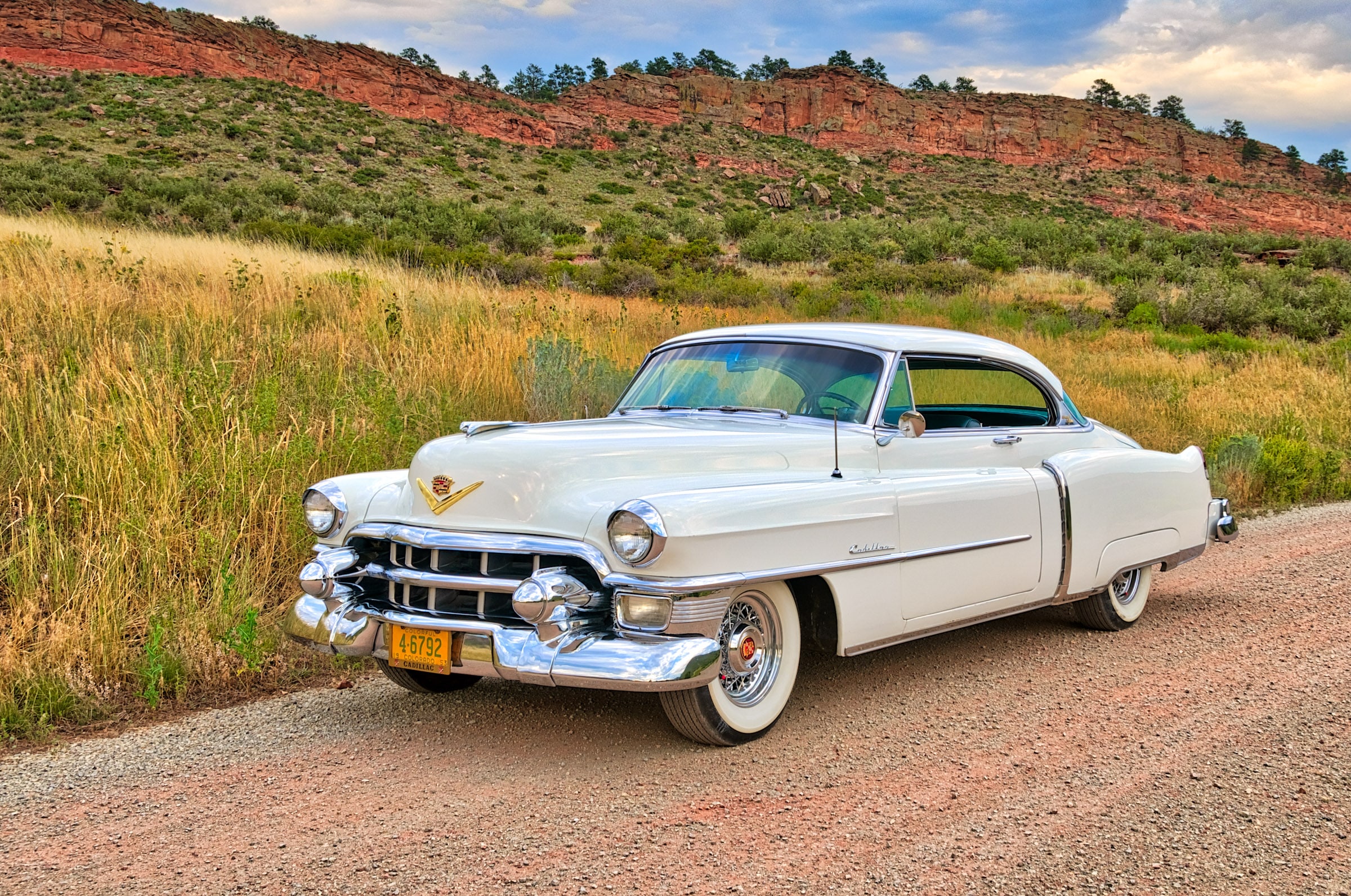 1953 Cadillac Coupe deVille - Left front three-quarter view with red rocks in the distance.