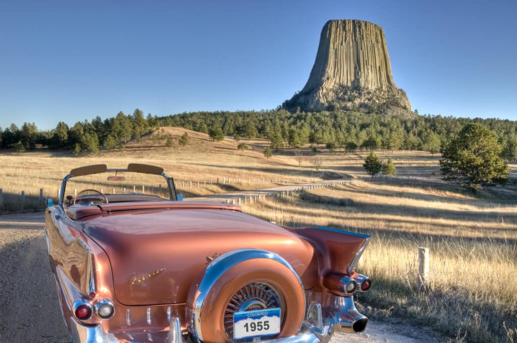 Cadillac convertible in Devils Tower National Monument, rear view with continental kit.