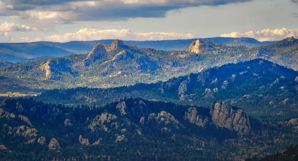 This is a view across the Black Hills toward the Crazy Horse Memorial from Mount Coolidge Fire Tower near Custer, South Dakota.