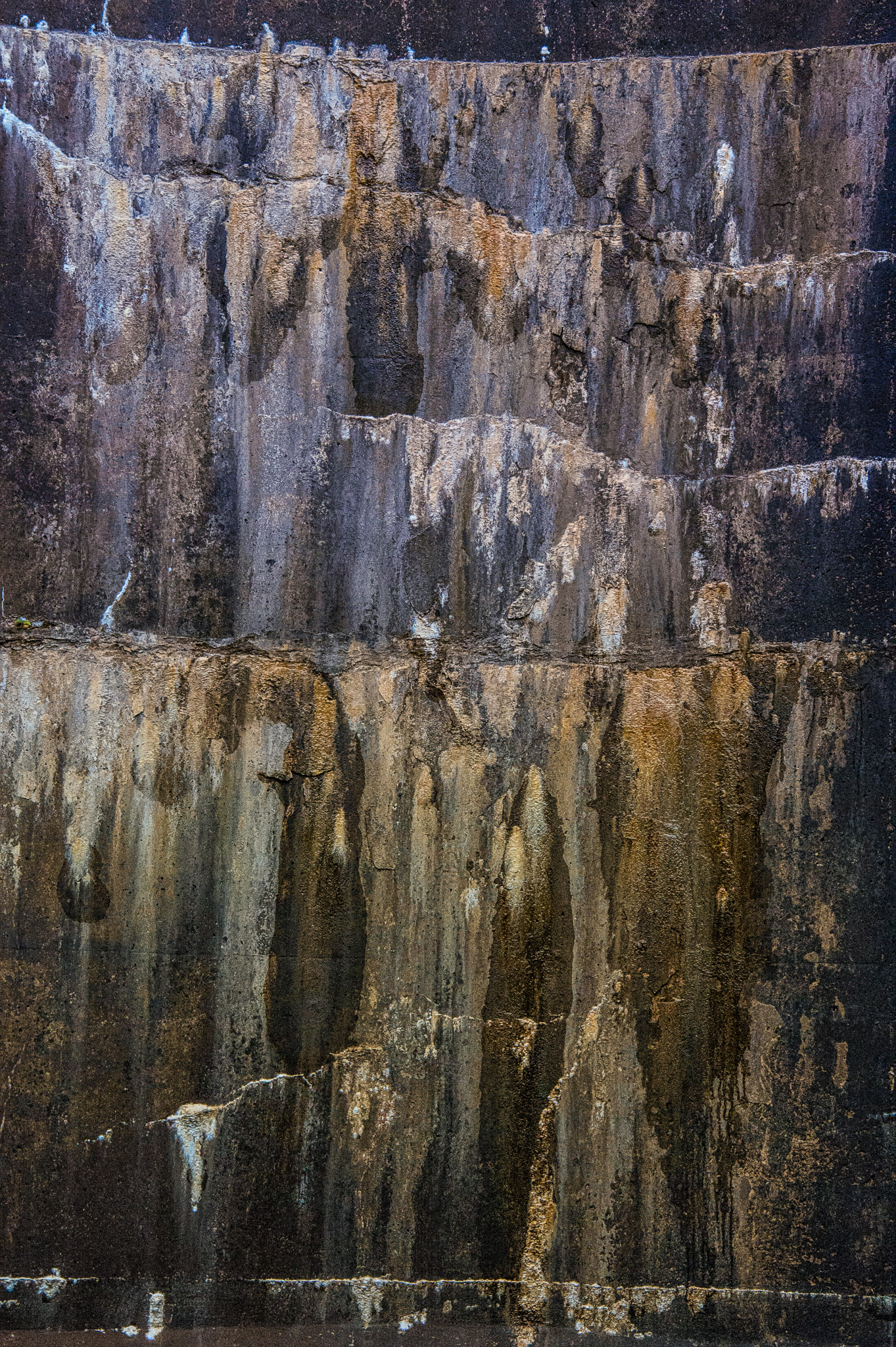 Water stains create abstract patterns on the dam spillway at Sylvan Lake in Custer State Park, South Dakota.