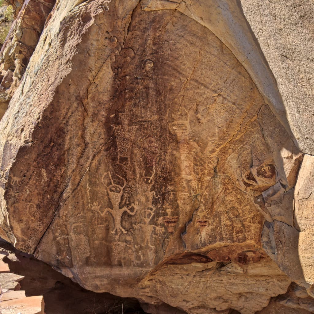Petroglyphs in "Swelter Shelter" are thought to be from the Fremont Culture. Remnants of a red color can be discerned on the torsos of several of the figures. Swelter Shelter is located along Cub Creek Road in Dinosaur National Monument near Vernal Utah.