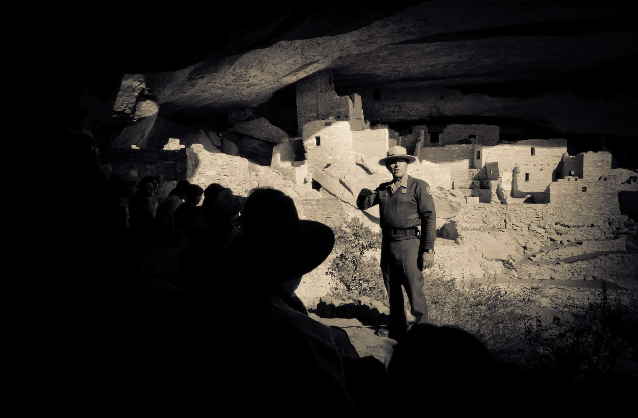 An Interpretive Ranger talks to a group of visitors in Cliff Palace at Mesa Verde National Park near Cortez, Colorado.
