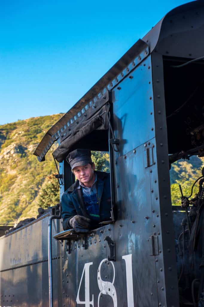 Portrait of the engineer of the Durango & Silverton Photography train as it makes its way along the Animas River between Durango and Silverton, Colorado.
