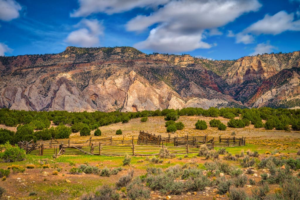This scenic corral is along side Blue Mountain Road, outside of Dinosaur National Monument. The whitehogbacks on the south side of Blue Mountains are formed from Weber Sandstone.