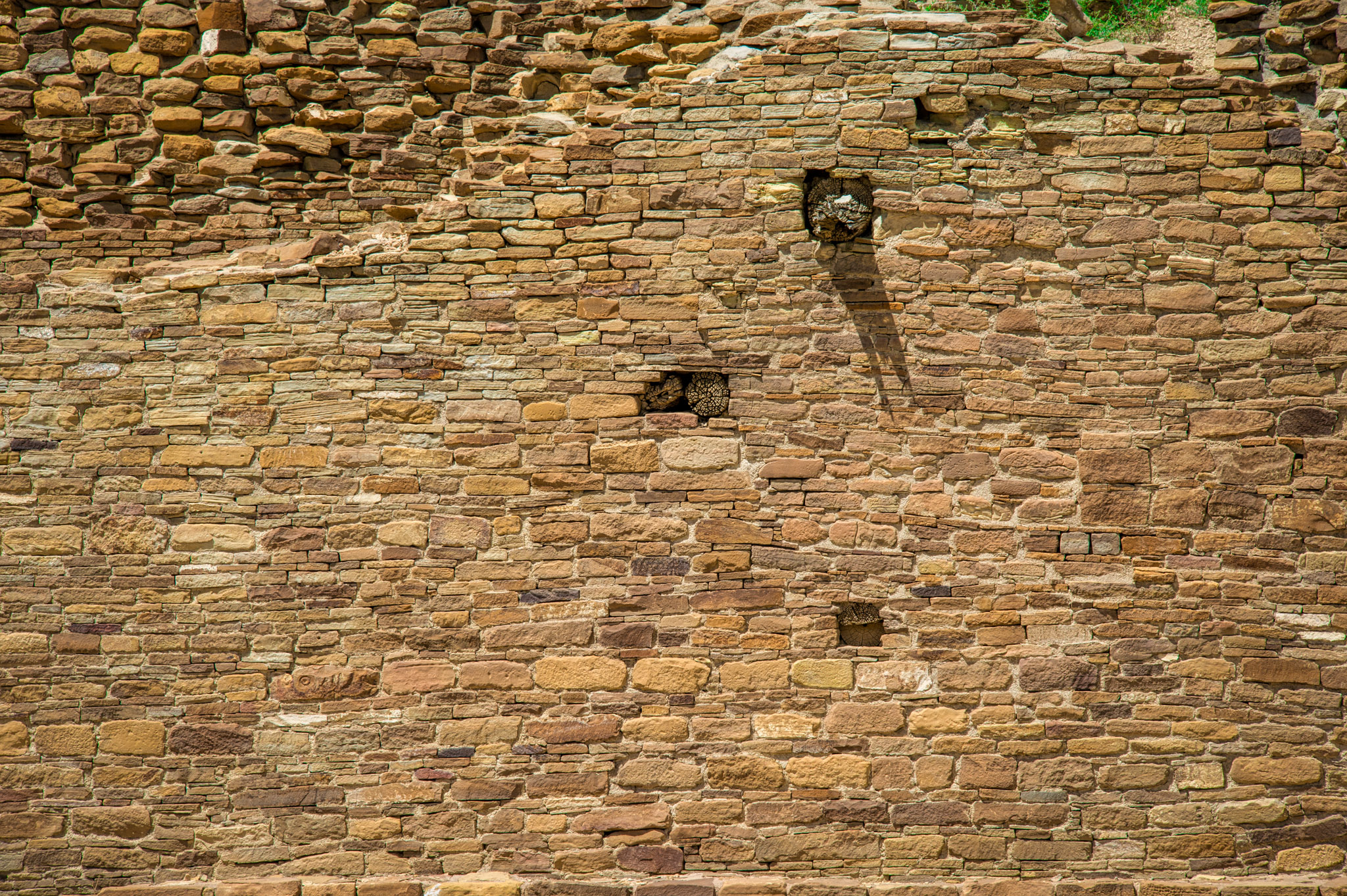 This wall at Pueblo del Arroyo in Chaco Canyon,New Mexico, shows evidence of having been repaired or altered. You can also see ends of vigas, or roof beams, protruding from the wall.