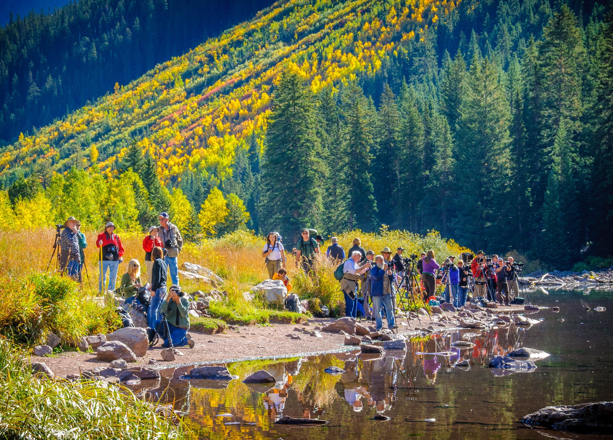 A group of photographers trying for shots of the Maroon Bells in the Maroon Bells Recreation Area near Aspen, Colorado.